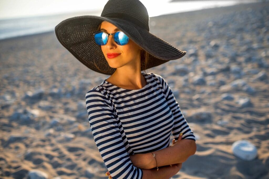 woman wearing a hat and sunglasses to maintain anti aging 